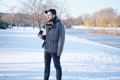 Full length of man on snow covered sidewalk in winter