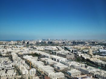 High angle view of townscape against clear blue sky