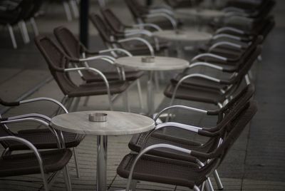 Close-up of empty chairs by table