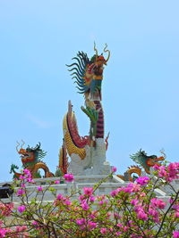 Low angle view of statue on flower