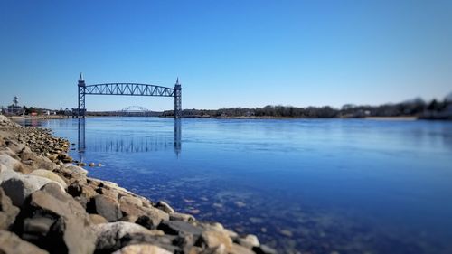 Bridge over river against blue sky