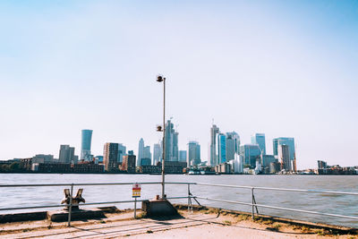 Modern buildings in city against clear sky