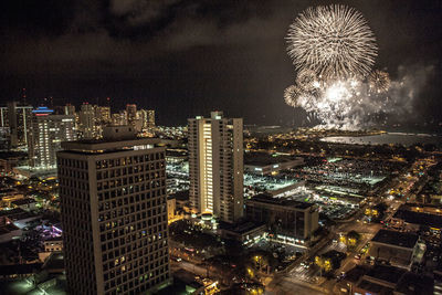 View of cityscape with fireworks exploding at night
