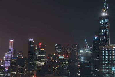 Low angle view of illuminated cityscape at night