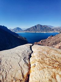 Scenic view of mountains against clear blue sky