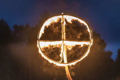 Close-up of illuminated lamp against sky during sunset