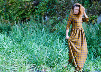 Portrait of young woman in grass