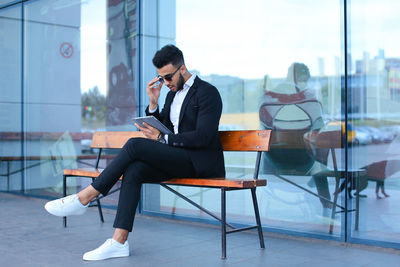 Side view of businessman using mobile phone