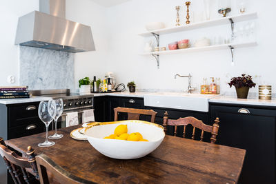 Lemons in bowl on table at home