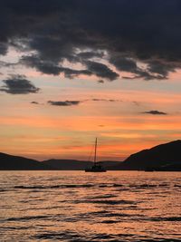 Scenic view of sea against orange sky