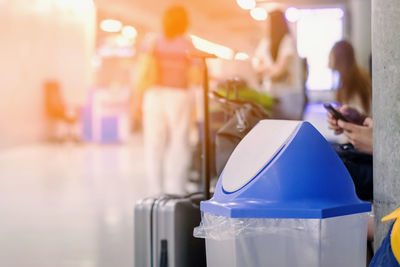 Close-up of people using laptop on table