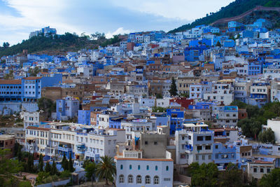 Houses in town against sky