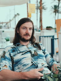 Portrait of young man sitting outdoors