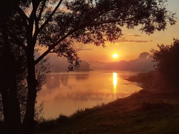 Scenic view of lake against sky during sunset