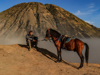 Rear view of man standing on mountain