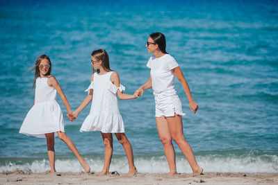 Friends standing at beach