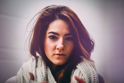 Portrait of beautiful woman against wall