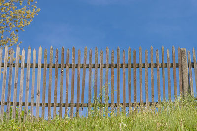 Fence on field against sky