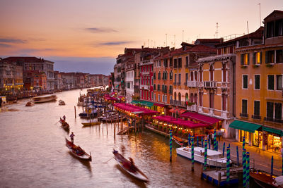 Boats in canal against buildings
