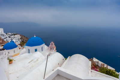 Viewl of blue dome  in the village of oia, santorini, greece