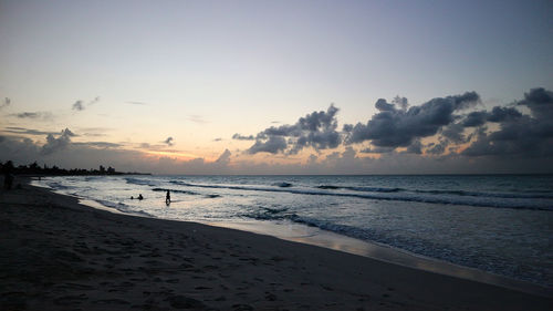 Scenic view of beach against sky during sunset