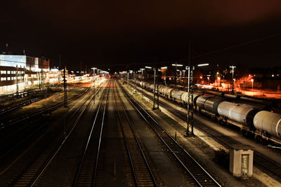 High angle view of illuminated railroad tracks at night
