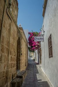 Narrow alley amidst buildings against sky