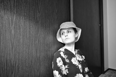 Portrait of boy wearing hat against wall