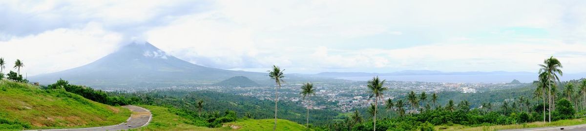 Scenic view of mountains against cloudy sky