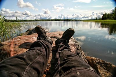 Low section of woman relaxing on lake