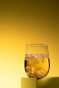 Close-up of drink against yellow background