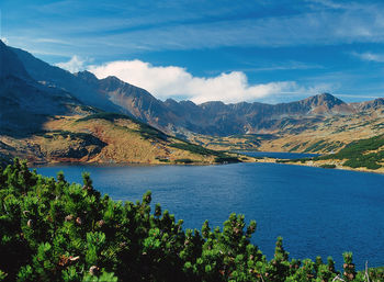 Scenic view of calm lake against mountain range