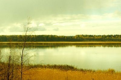 Scenic view of lake against cloudy sky