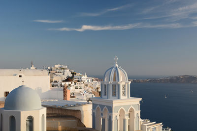 Church by sea against sky