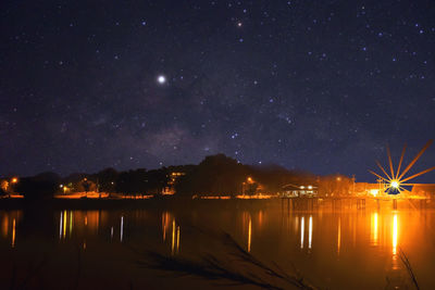 Scenic view of lake against sky at night