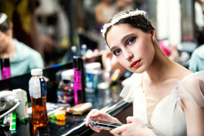 Portrait of young woman using mobile phone