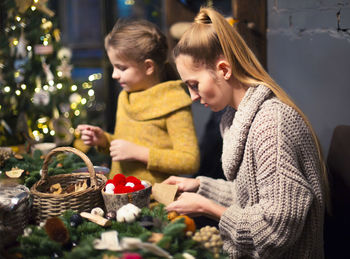 Mother and daughter dong christmas decoration at home