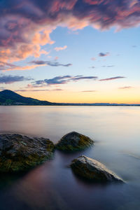 Scenic view of lake against sky during sunset