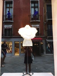 Full length of woman with umbrella walking in city