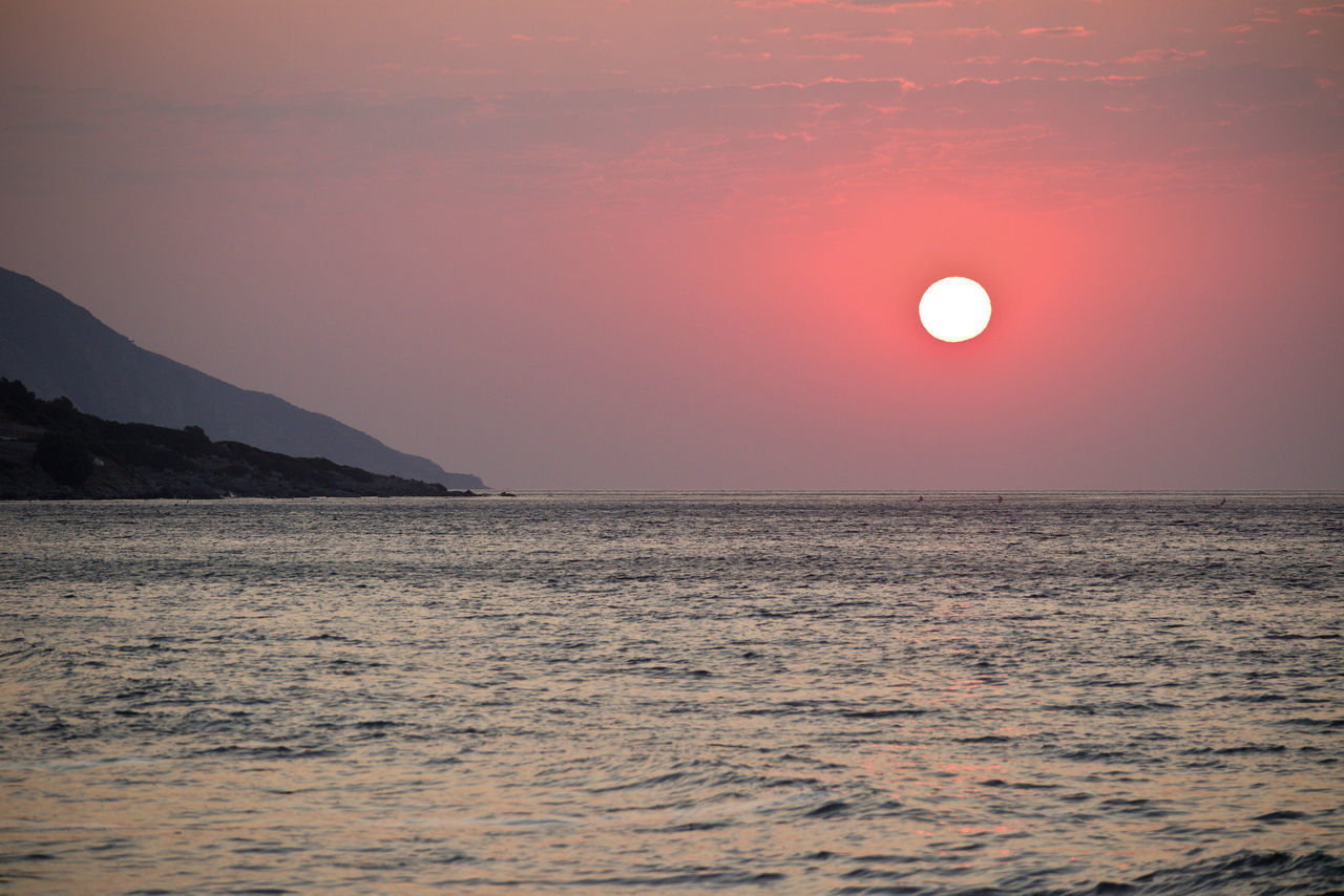 SCENIC VIEW OF SEA AGAINST ORANGE SKY DURING SUNSET