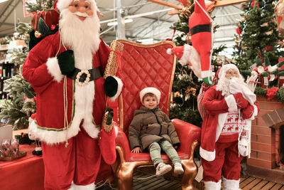 A boy in a hat visiting santa claus