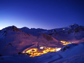 Scenic view of snowcapped mountains against clear blue sky