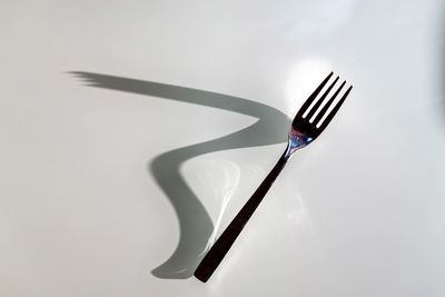 Close-up of fork on white background