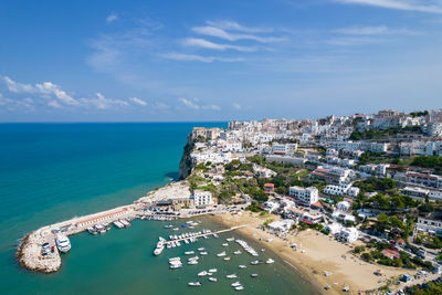 High angle view of sea and buildings against sky