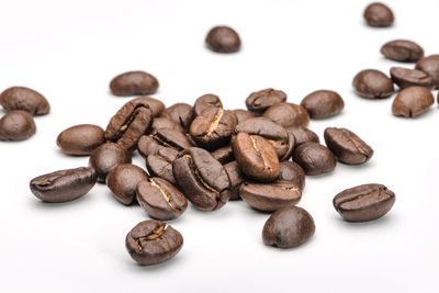 Close-up of coffee beans against white background