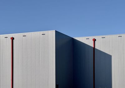 Low angle view of modern building against clear blue sky