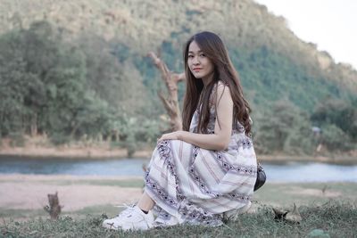 Portrait of a beautiful young woman sitting outdoors