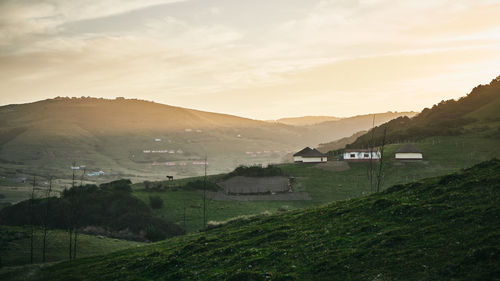 Scenic view of field against sky during sunset