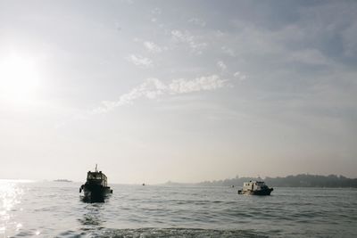 Boat sailing in sea against sky