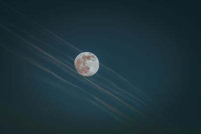 Low angle view of moon against sky at night